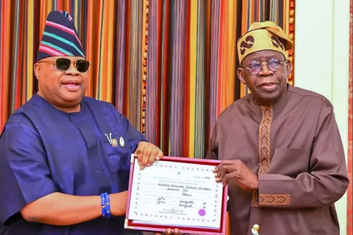 An Image File of Osun State Governor, Ademola Adeleke, presenting his return certificate to President Bola Tinubu at the Presidential Villa, Abuja.